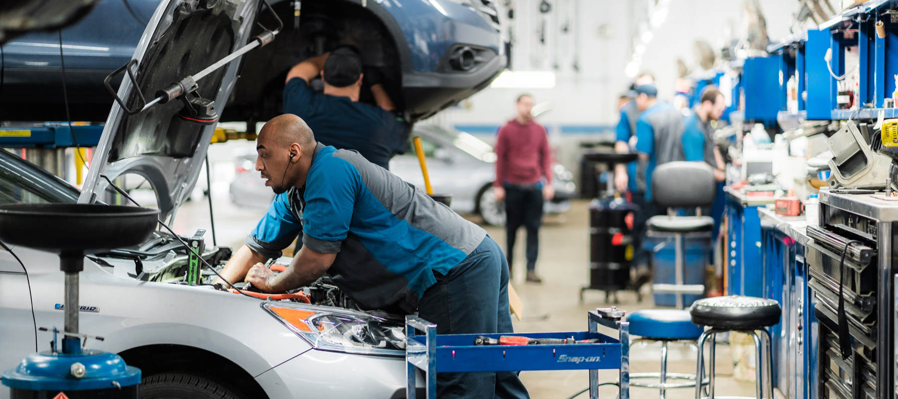 technician-works-on-car-engine